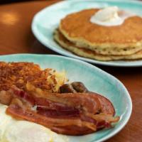 Douglas Street Sampler · Two eggs, two bacon strips, two sausage links, and one slice of ham. Served with two hotcake...