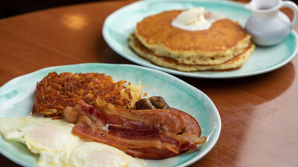 Douglas Street Sampler · Two eggs, two bacon strips, two sausage links, and one slice of ham. Served with two hotcakes and hash browns.