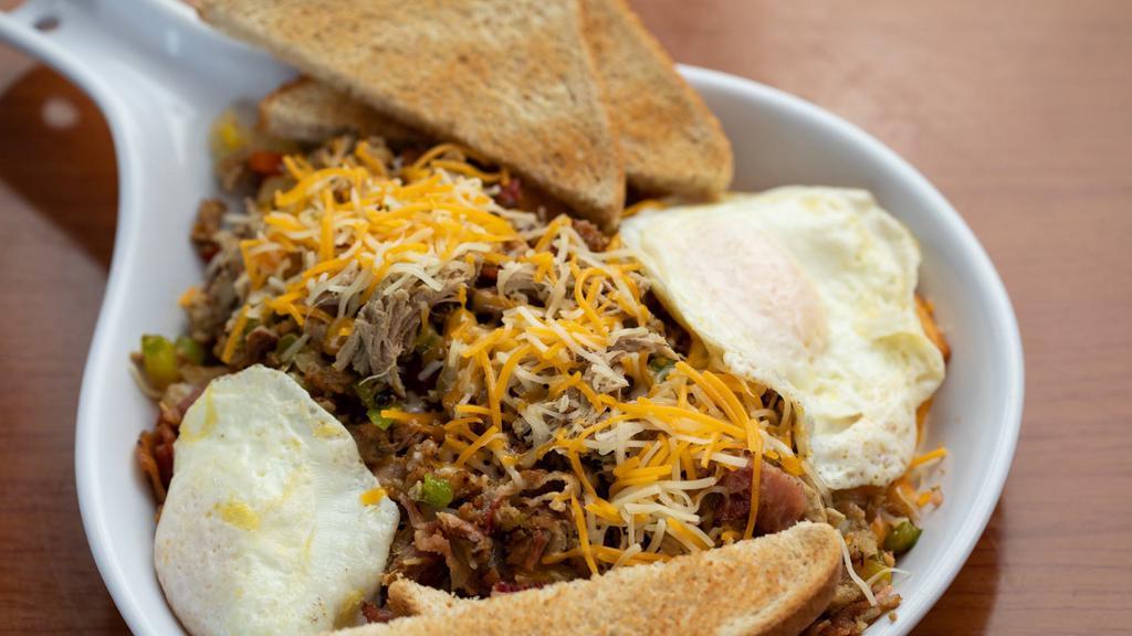 Pig And Pepper Skillet · Pulled pork, bacon, sausage, peppers, onions, cheese over diced potatoes served with two eggs your way and toast