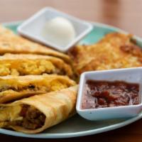 Breakfast Quesadilla · Grilled flour tortilla filled with eggs, sausage, pico, and cheese.  Served with hash browns...