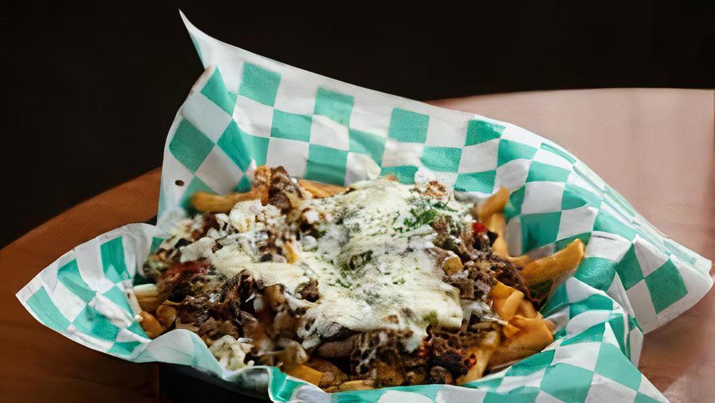 Loaded Philly Fries · Fries smothered in cheese sauce, topped with philly steak, peppers, onions, and mozzarella cheese.