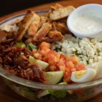 Chicken Cobb Salad · Grilled chicken served over mixed greens, egg, tomatoes, onions, cucumbers, bacon, bleu chee...