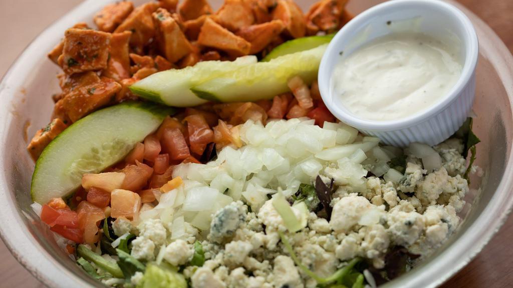 Buffalo Chicken Salad · Spicy. Mixed greens, grilled chicken tossed in buffalo sauce, tomatoes, onions, bleu cheese crumbles, croutons, and your choice of dressing