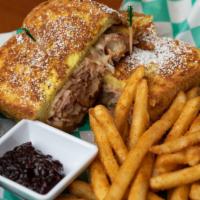 Monte Cristo · Ham, Turkey, and Swiss in between two pieces of french toast topped with powdered sugar and ...