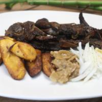 Lamb Dibi · African style grill lamb, season with our signature rub. Served with onion sauce and side of...
