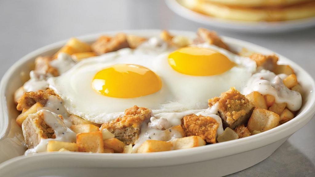 Chicken-Fried Steak Skillet* · Smothered with country sausage gravy and onions on breakfast potatoes.