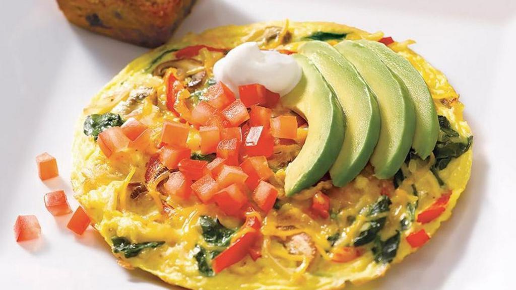 California Frittata* · Frittata filled with sautéed potatoes, onions, mushrooms, red peppers and spinach. Topped with melted cheddar cheese, tomatoes, avocado and sour cream.