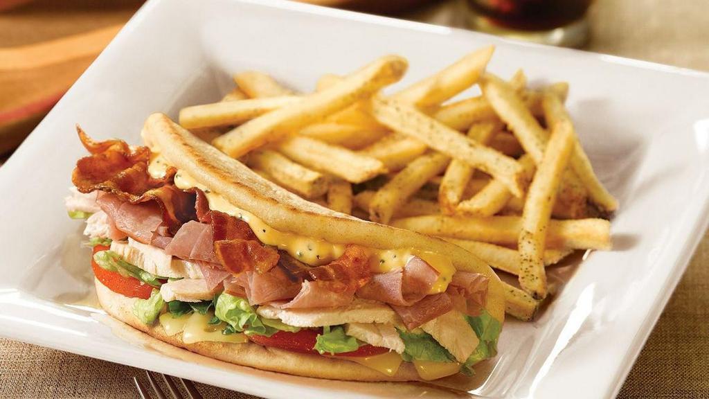Honey Mustard Club Pita · Slow-roasted, hand-carved turkey, ham, bacon, tomato, lettuce and melted Swiss cheese with honey mustard sauce on a grilled pita.