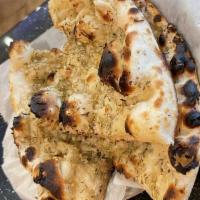 Garlic Rosemary Naan · Bread prepared from refined flour flattened and pressed with topped garlic and herbs baked i...