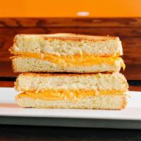 The Og · American cheese and cheddar cheese spread on Texas toast. Served with a side of tomato soup ...