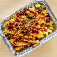 Cowboy Mac · Our artisan mac, tossed with smoked brisket from Deez Nachos KC, and topped with a fried but...
