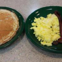 Cakes Eggs Meat · Two cakes, two eggs with either bacon, ham or links. Served with side of fruit