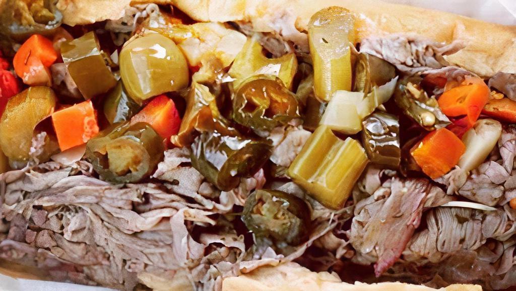 Italian Beef Sandwich · Top Sirloin Beef Seasoned, Pepper Jack Cheese, Hot or Mild Giardiniera, Au Jus for Dipping, On a Fresh Baked Sesame Seeded Roll.