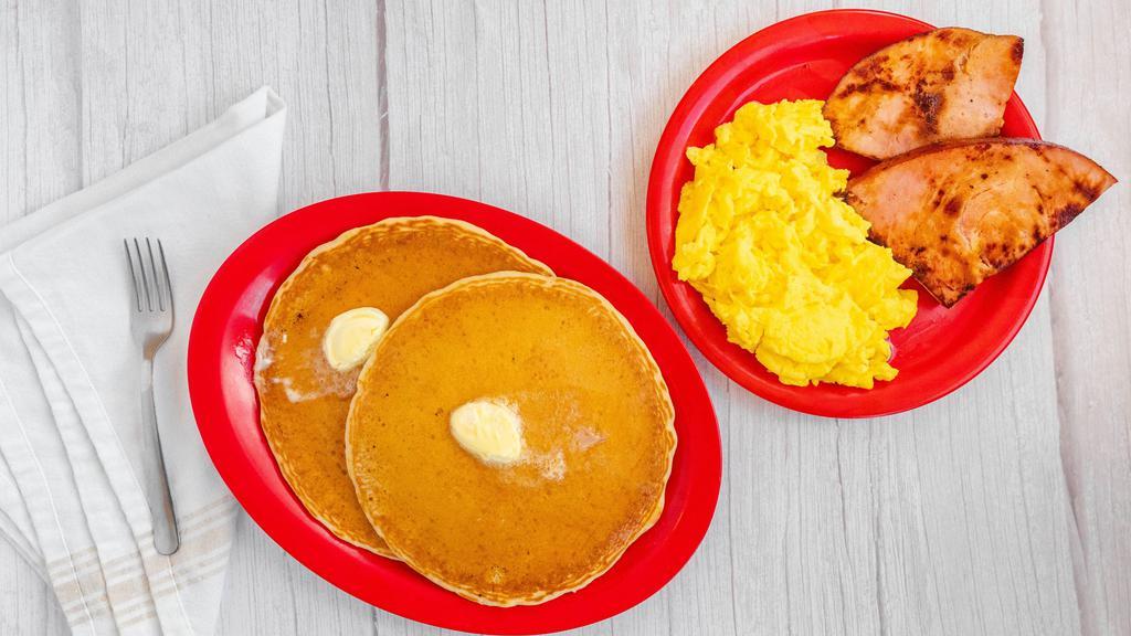 Pancake Breakfast (2) · Two large fluffy pancakes, with 2 eggs and your choice of bacon, ham, or sausage.