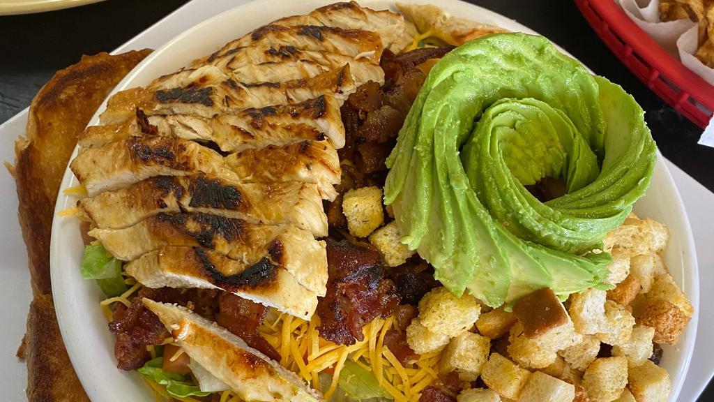Grilled Chicken Cobb Salad · Tender grilled chicken breast on a bed of lettuce, tomato, onion, cheese, avocado, and croutons. Served with Texas toast and your choice of dressing.