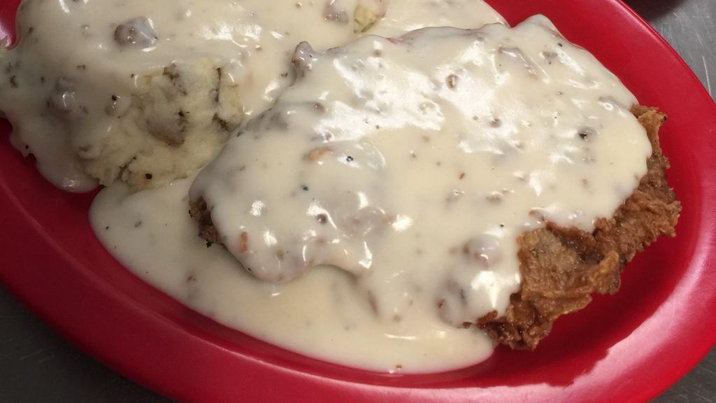 Chicken Fried Steak · Our tenderized steak hand-breaded, fried, and covered in gravy. Served with the vegetable of the day, your choice of fries, mashed potatoes, or chips, and a slice of Texas toast.