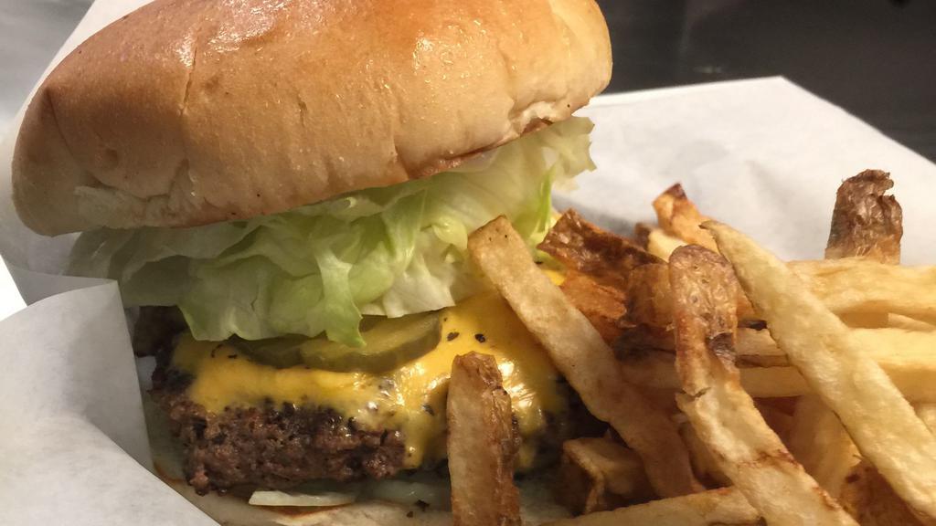 Cheeseburger · 1/2 pound burger, served with fresh cut fries or homemade chips, lettuce, tomato, pickles and onions.