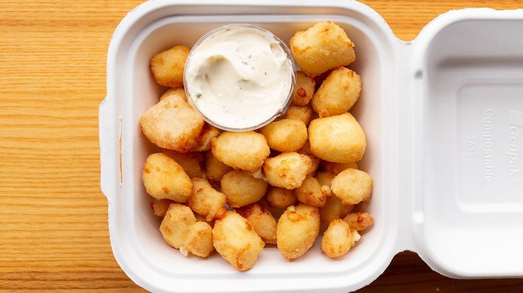 Cheese Curds · Pile of white cheddar cheese curds, breaded and deep fried, served with garlic-herb sauce (v)