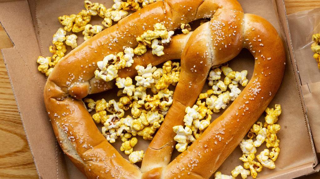 Giant Pretzel · Good City Pils basted Milwaukee Pretzel Co. giant pretzel served with house creamy mustard and curry popcorn (V)