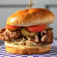 Fried Chicken Sandwich · Buttermilk fried chicken thigh tossed in our signature spice blend, house slaw, Roma tomato,...
