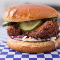 Nashville Hot · Fried Buttermilk chicken tossed in Nashville Hot Sauce, and house pickles. Served on a Brioc...