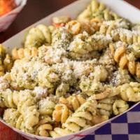 Pesto Pasta Salad · With Pesto, feta cheese Roma tomato and red onion topped with parmesan