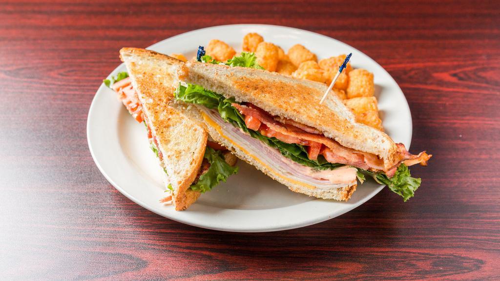 Clubhouse · Wheatberry bread, cheddar cheese, turkey, ham, bacon, lettuce, tomato, hot ham mac and cheese with mayo or spicy mayo.
