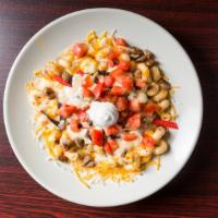 Taco Mac · Seasoned beef mixed in with our homemade Mac & Cheese topped with tomato's, tortilla strips,...