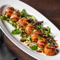Japanese Takoyaki · Spicy. Flash-fried soft dough ball filled with octopus bits. Topped with eel sauce and spicy...