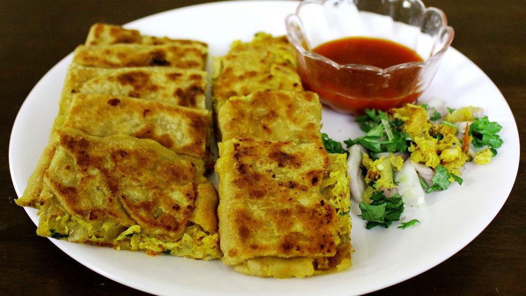 #11. Chicken Mughlai · Multi layers of flour stuffed with eggs, shredded chicken and fresh herbs.