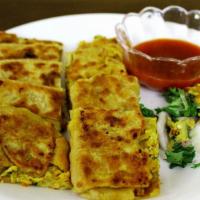 #10. Meat Mughlai Paratha · Multi layers of flour stuffed with eggs, ground meat and fresh herbs.