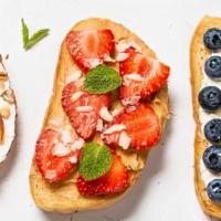 Andalusian Snack · Toasted bread with cream cheese and seasonal fruit.