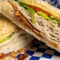 Turkey Club · Oven roasted turkey, crispy strips of bacon, provolone cheese, lettuce, tomato and mayo.