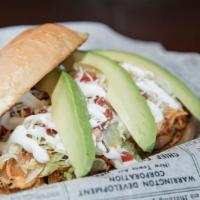 Torta · A Mexican sandwich with choice of meat, refried beans, lettuce, tomatoes, sour cream, cheese...