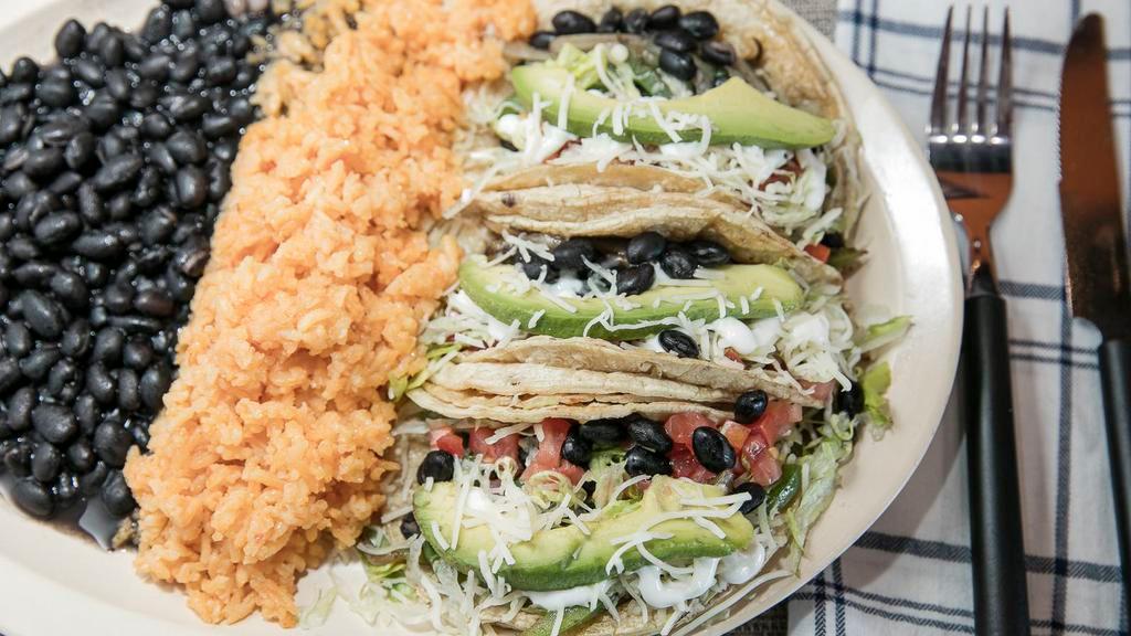 Vegetarian Taco Plate · Vegetarian. Two corn tortillas with black beans, grilled green peppers, grilled onion, tomatoes, lettuce, sour cream, avocado, and cheese.