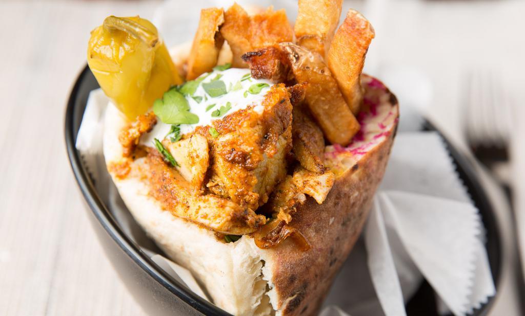 Shawarma Sandwich · Middle-eastern style chicken thighs flavored with our special seasoning cooked on a rotisserie.
