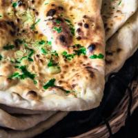 Garlic Naan · Traditional Indian bread baked in clay oven with a hint of fresh garlic.