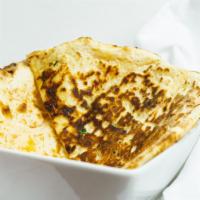 Cheese Naan · Traditional stuffed Indian bread with herbs and cheese.