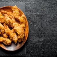 Chicken Tenders · Breaded strips of chicken fried till crispy and golden-brown, served with a ranch dressing.