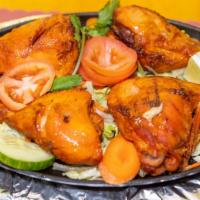 Chicken Tandoori · Chicken leg marinated in yogurt, garlic, spices and baked in clay oven.