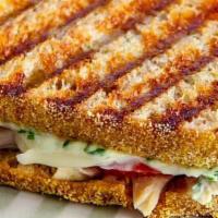 Turkey Lovers Panini · Filled with turkey and cheddar cheese with cranberry spread. Served with chips & Pickle
