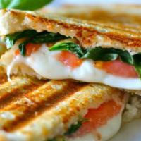 Caprese Panini · Filled with fresh mozzarella, tomatoes, basil and balsamic glaze. Served with chips and .