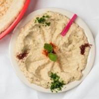 Hummus · A blend of cooked chickpeas lemon and tahini, served as a cold dip with pita bread.