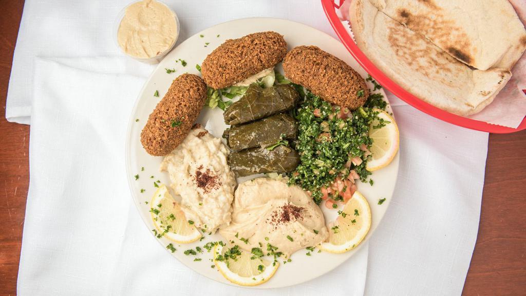Vegetarian Combination Plate · Combination of three falafel, three stuffed grape leaves, hummus, baba ghannoug, and tabouleh salad served with pita bread.