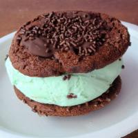 Mint Chip Super Sammy · Mint Chip ice cream in between two double chocolate chunk cookies and topped with chocolate ...