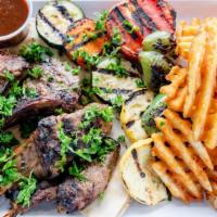 Lamb Chops · Four pieces of french cut lamb chops, marinated and charbroiled, served with grilled vegetab...