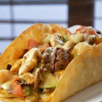 Taco Loco · Big crispy flour taco shell filled with beans, chicken or beef tips, cheese sauce, lettuce, ...
