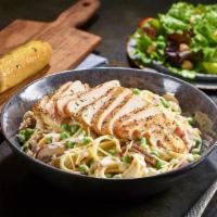 New Chicken Carbonara · Grilled chicken served atop fettuccine tossed with alfredo sauce, bacon, peas, roasted baby ...