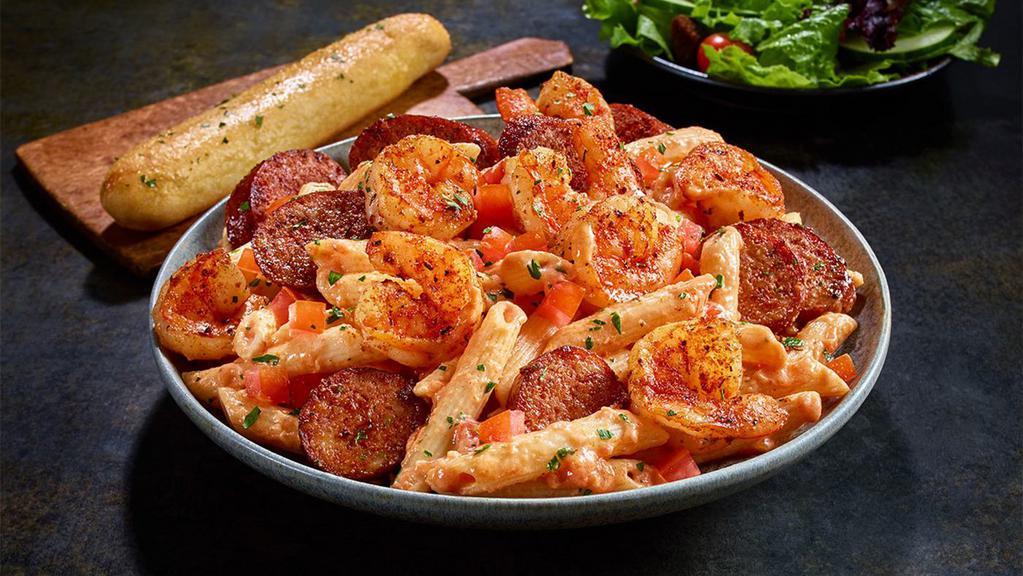 New Blackened Shrimp & Sausage Pasta · Penne pasta tossed with a creamy tomato and alfredo sauce and finished with diced tomatoes.