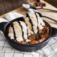 Chocolate Chip Cookie Skillet · A freshly baked chocolate chip cookie served warm in a skillet with vanilla bean ice cream a...